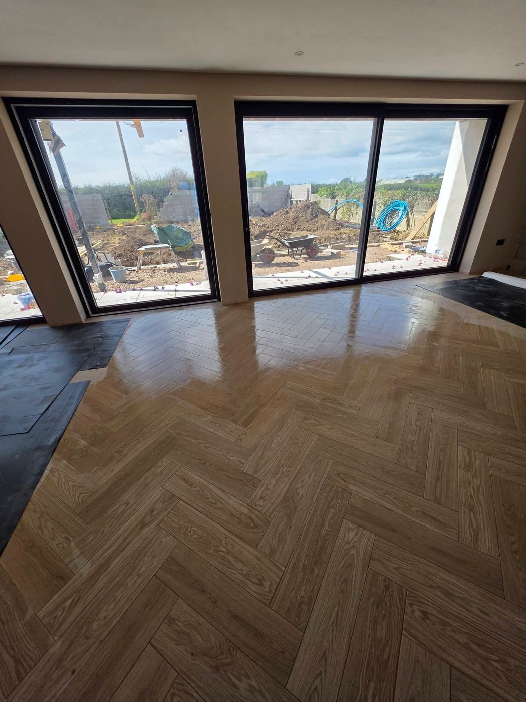 Finished herringbone floor running to the garden doors